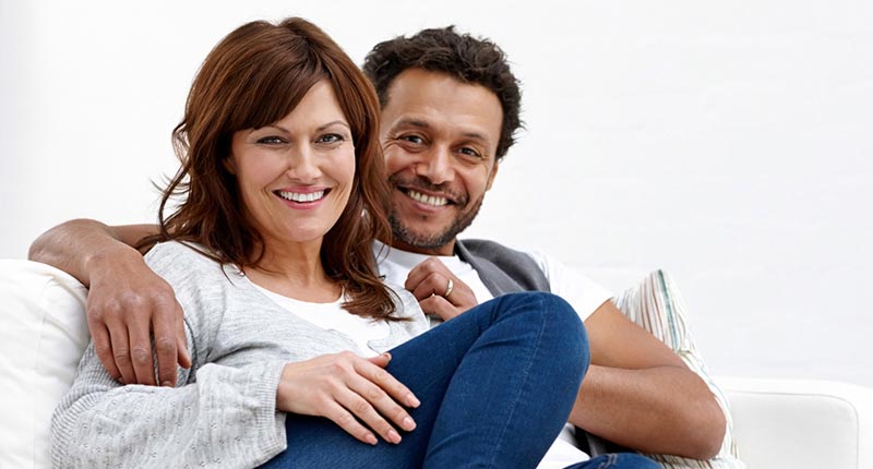 Couple smiling on sofa