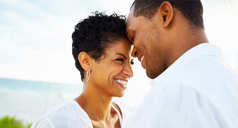 Smiling couple touching foreheads