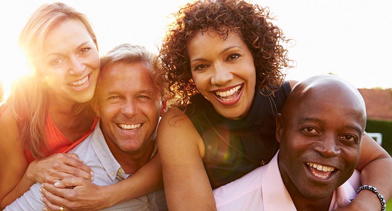 Two couples, hugging and smiling